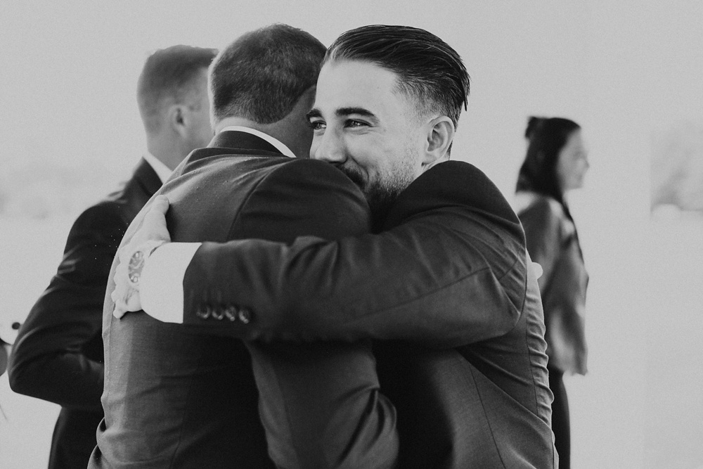 groomsmen hugging groom at pine valley country club wedding