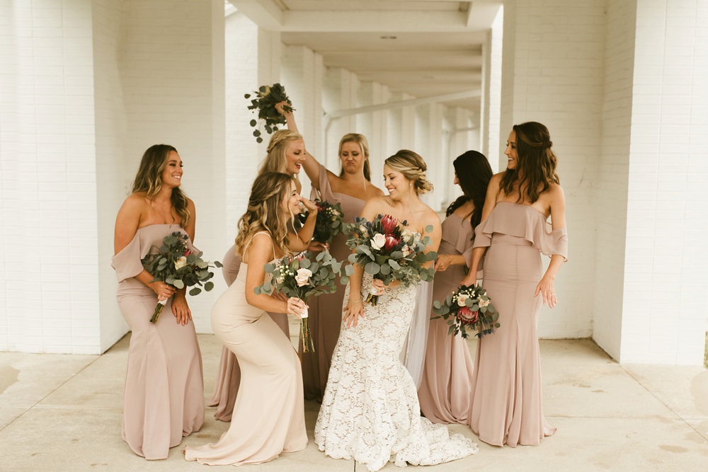 bridemaids in blush dresses with bride