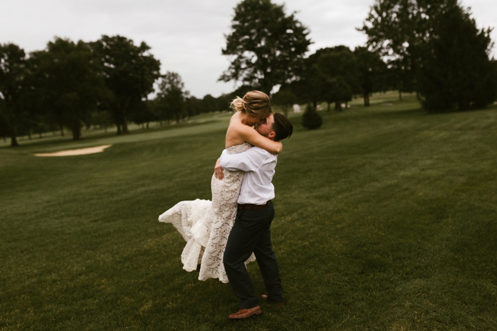 bride and groom kissing and hugging at pine valley country club wedding