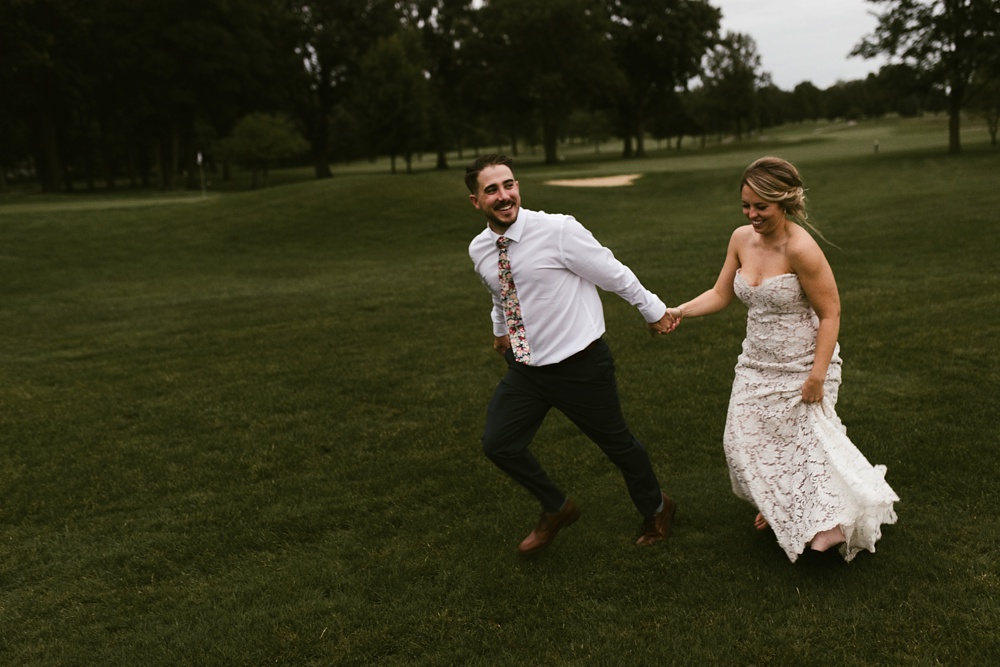 bride and groom running on golf course at pine valley country club wedding