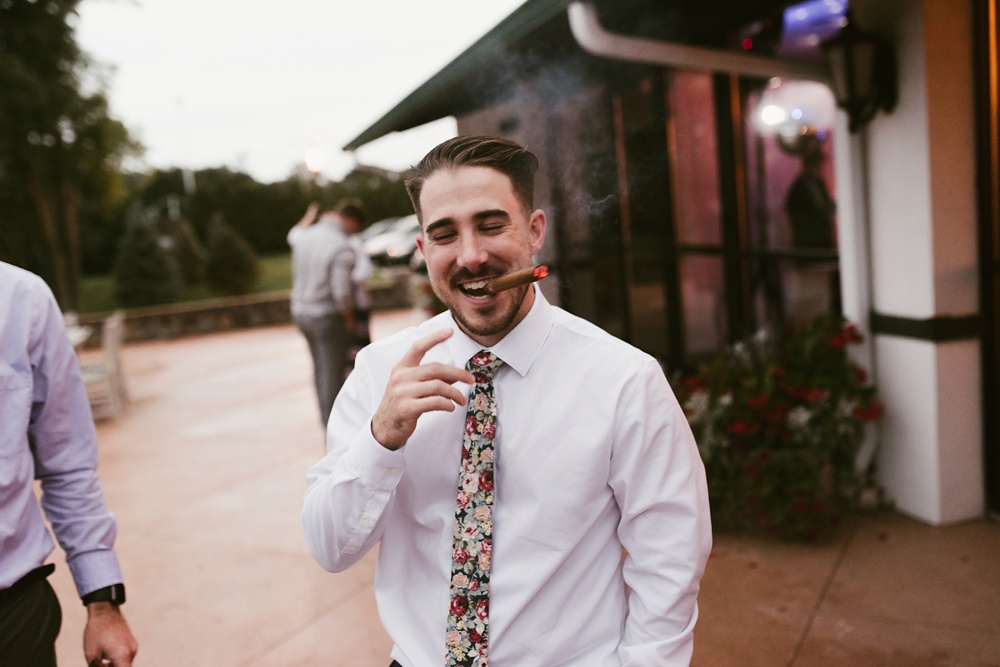groom smoking a cigar at pine valley country club wedding