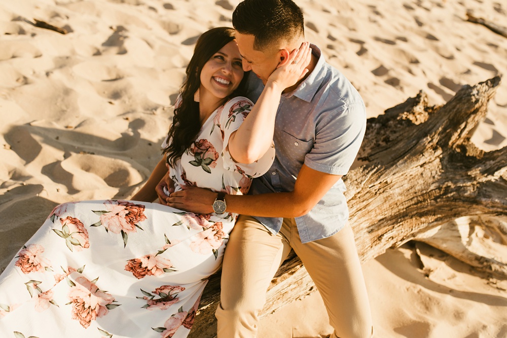 couple smiling at dune at warren dunes state park engagement session