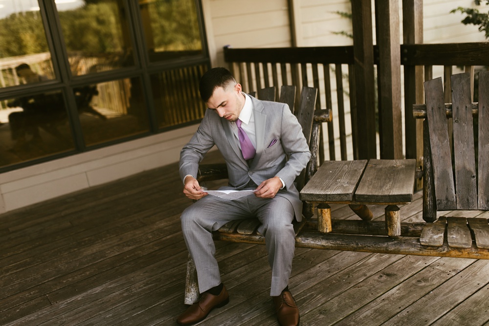 groom writing vows at metea county park fall wedding