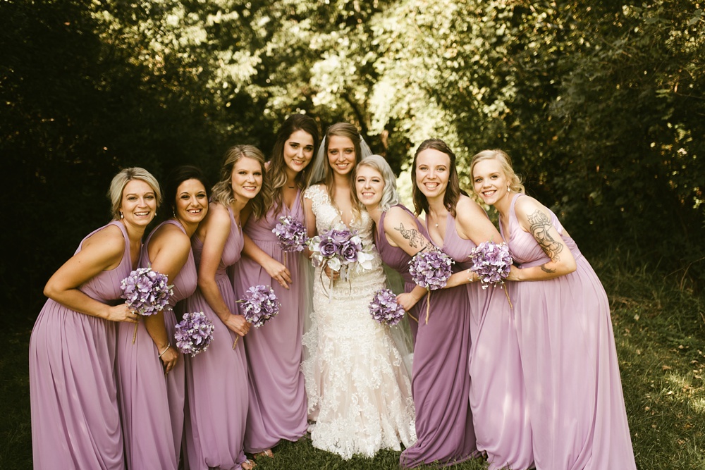 bride with bridesmaids in purple dresses at metea county park fall wedding