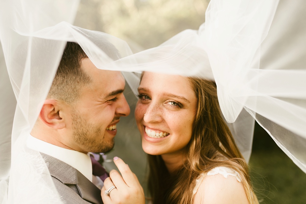 bride and groom smiling in veil at metea county park fall wedding