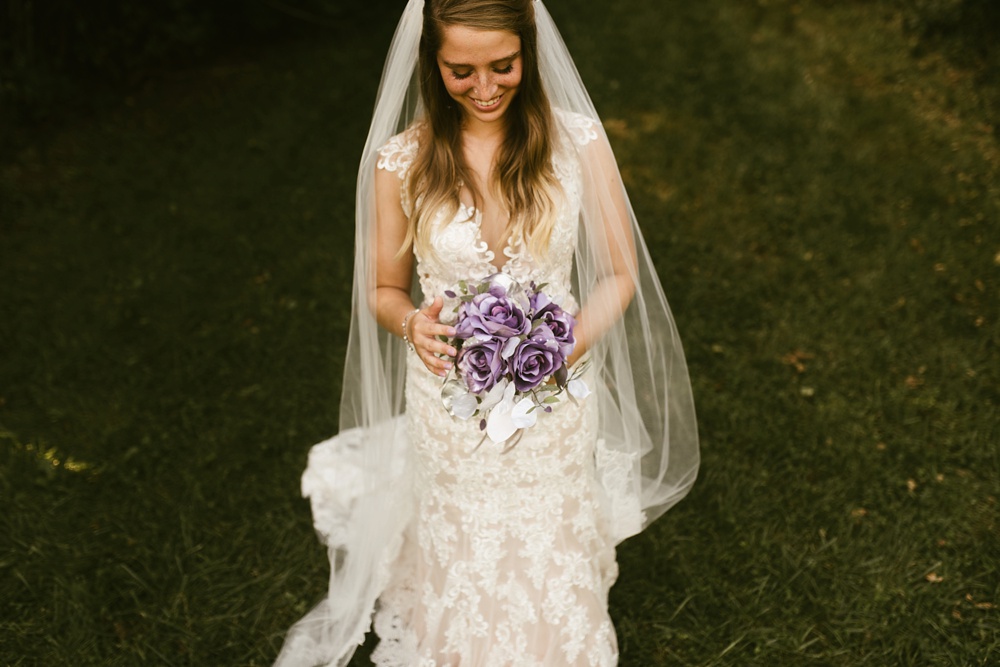 bride in one fine day lace dress with purple bouquet at metea county park fall wedding