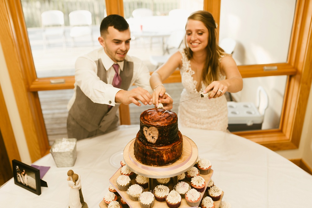 bride and groom cutting cake at metea county park fall wedding