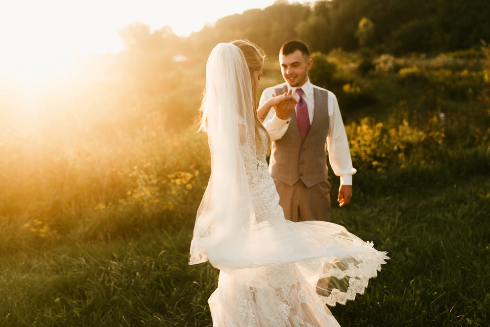 bride and groom dancing in field at sunset at metea county park fall wedding