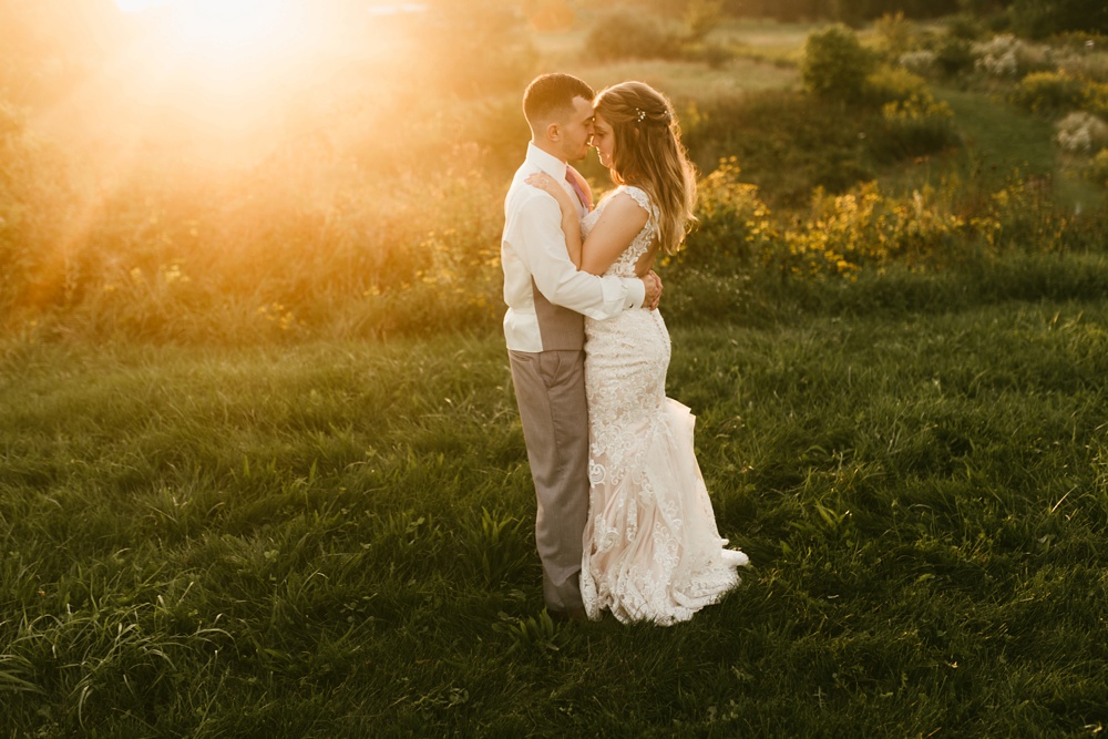 bride in groom in field at sunset at metea county park fall wedding