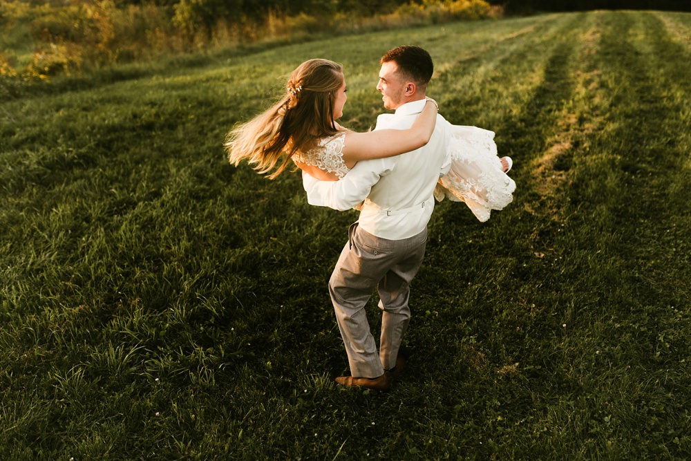 groom spinning bride at sunset at metea county park fall wedding