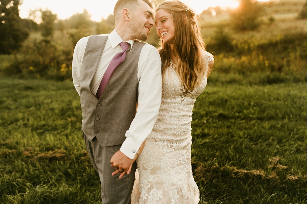 bride and groom smiling at sunset at metea county park fall wedding