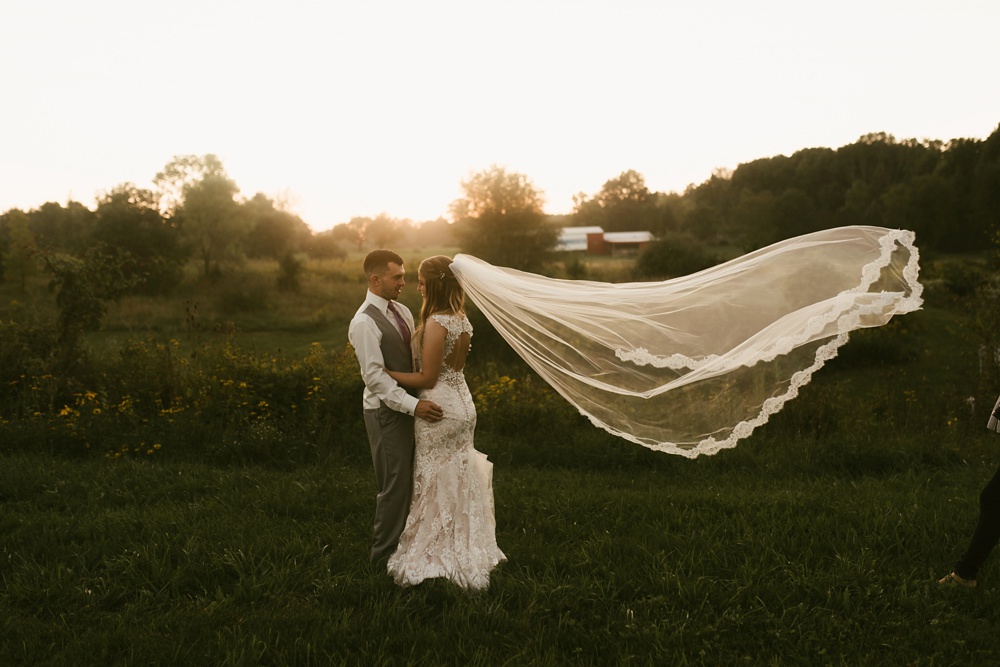 bride and groom with lace and tulle veil at metea county park fall wedding