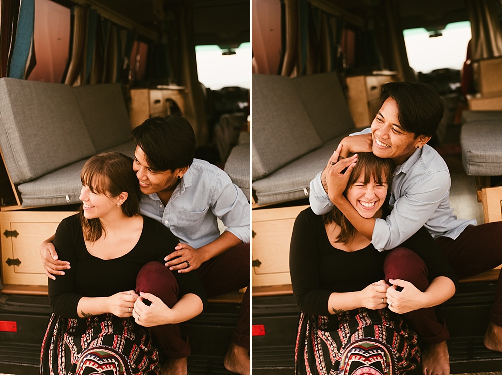couple laughing and hugging in front of their converted home van at warren dunes van life engagement shoot