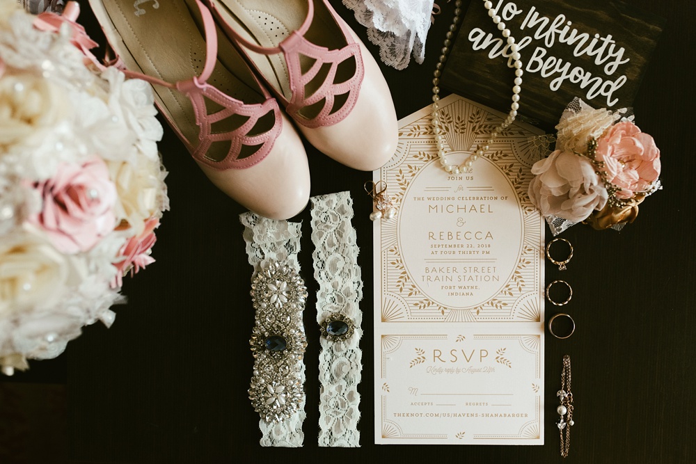 rose and gold wedding accessories and invitations at baker street station wedding