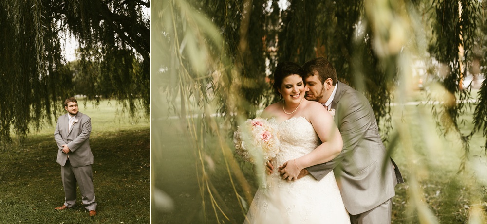 groom hugging bride under willow tree at foster park wedding