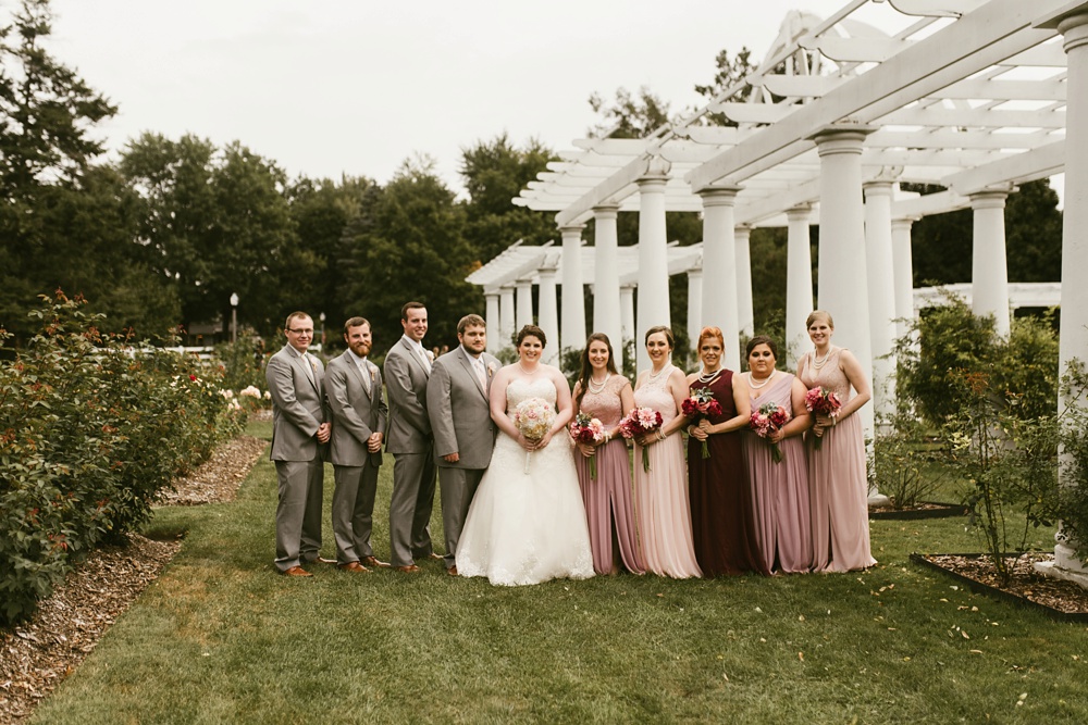 wedding party in gray tuxes and rose bridesmaid dresses at foster park wedding