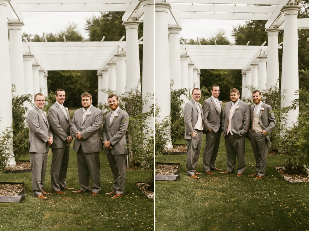 groomsmen in gray tuxes standing with groom at foster park wedding