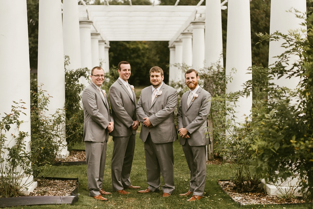 groomsmen and groom in gray tuxes at foster park wedding