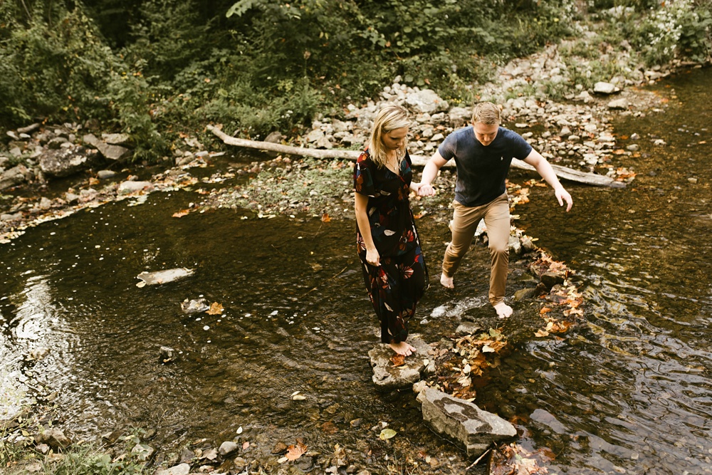 couple wading through water at france park engagement session