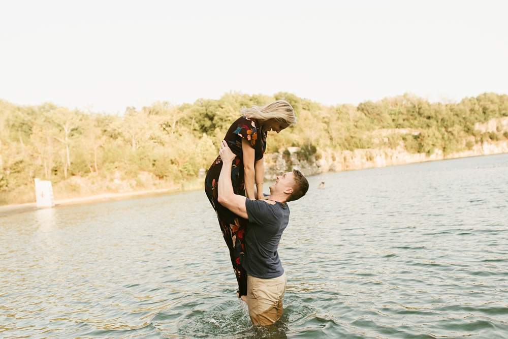 man lifting fiance out of water at france park engagement session