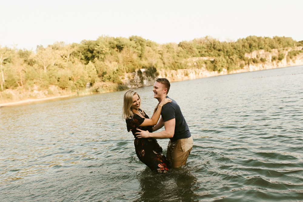 couple playing in water at france park engagement session