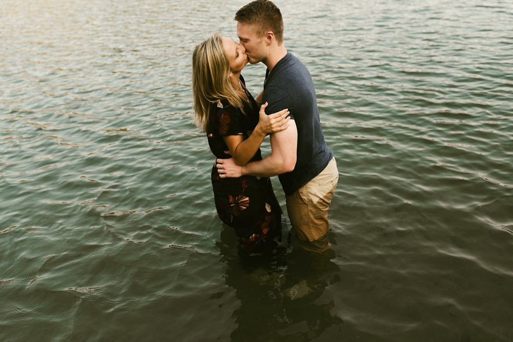 couple kissing in water at france park engagement session