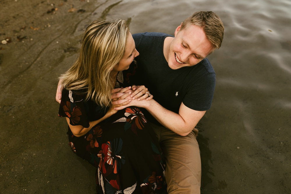 couple sitting in water at france park engagement session