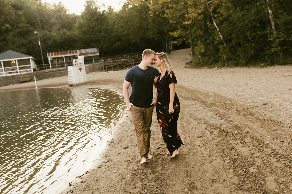 couple walking along beach at france park engagement session