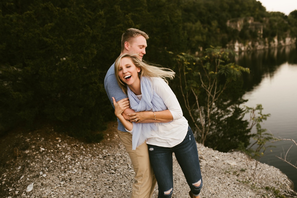couple laughing by water at france park engagement session