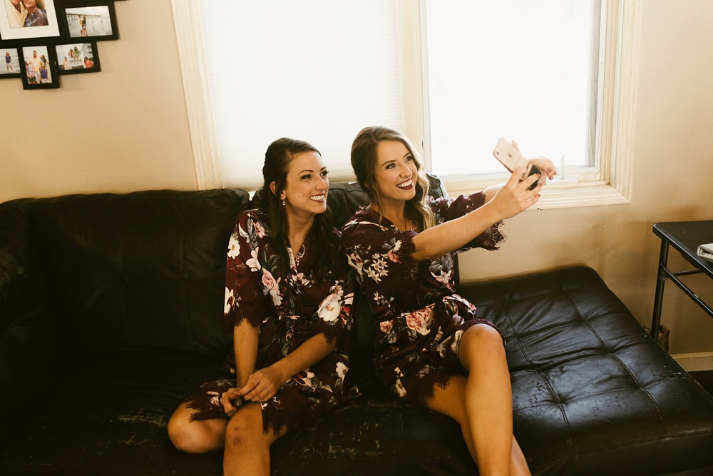 bridesmaids taking a selfie at purdue fort wayne international ballroom wedding