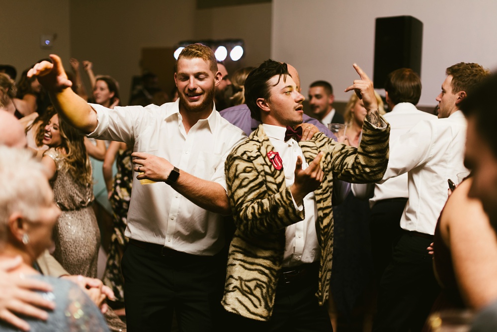 groomsmen dancing in leopard tux at purdue fort wayne international ballroom wedding