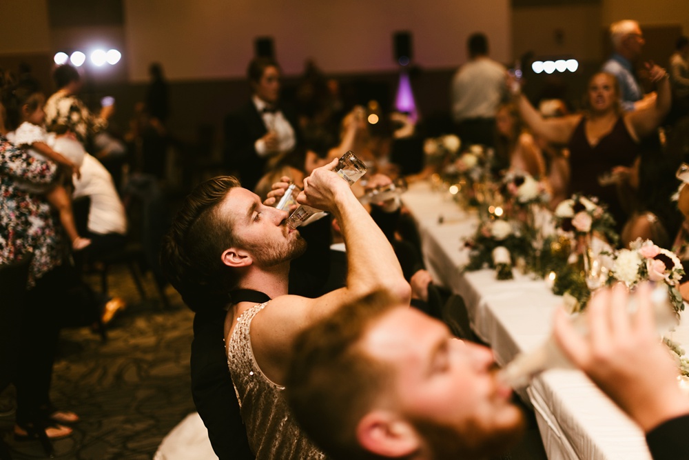 groomsmen chugging smirnoff at purdue fort wayne international ballroom wedding