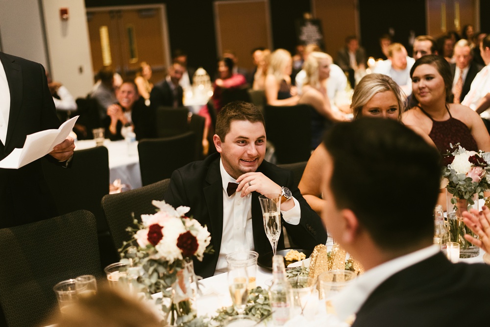 groom laughing during reception at purdue fort wayne international ballroom wedding
