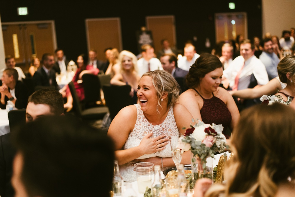 bride laughing at reception at purdue fort wayne international ballroom wedding