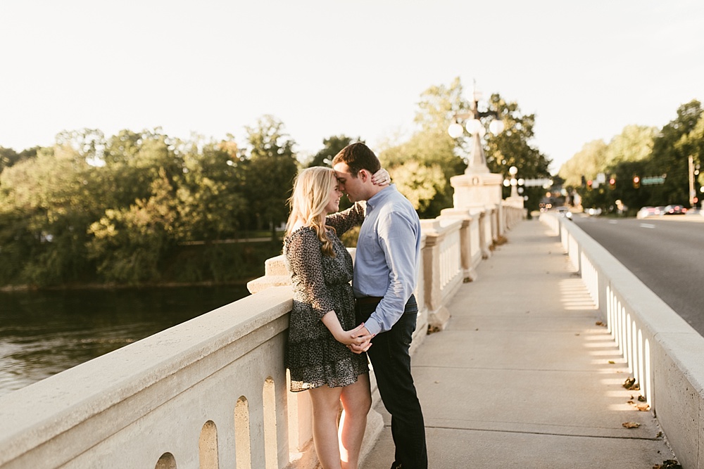 couple kissing on bridge at downtown south bend engagement session