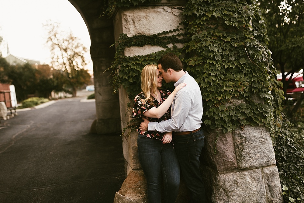couple hugging under bridge at downtown south bend engagement session