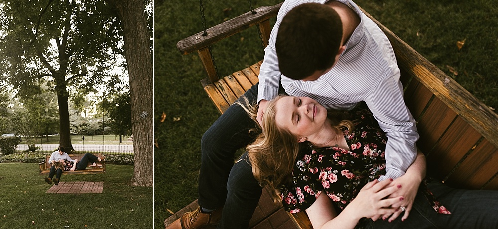 couple cuddling by bench at downtown south bend engagement session