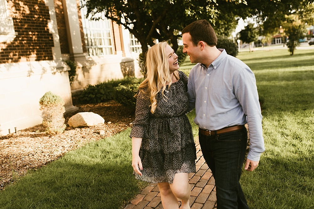 couple smiling at each other at downtown south bend engagement session