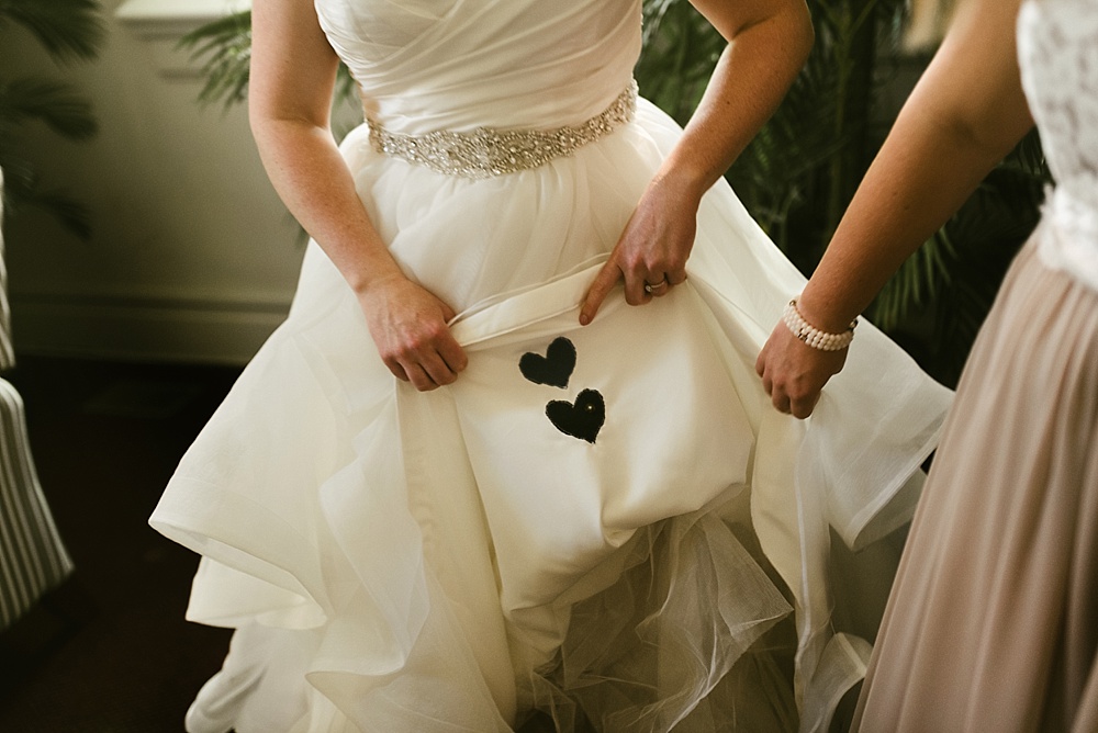 black hearts sewn into ellen's dress and bridal bouquet at precious blood catholic church wedding