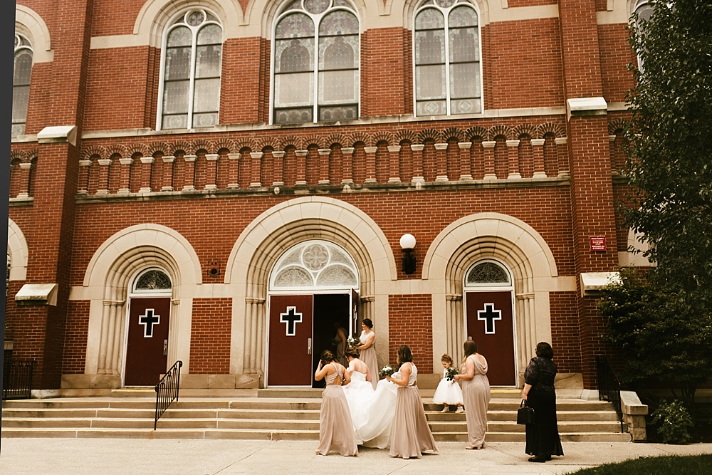 bridal party in rose dresses with bride at precious blood catholic church wedding