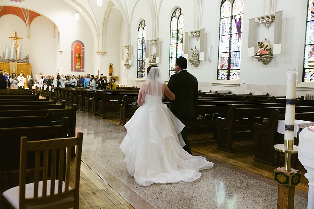 bride walking down aisle with father at precious blood catholic church wedding