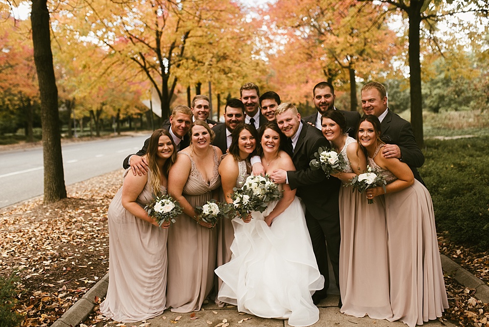 wedding party laughing with bride and groom at headwaters park fall wedding