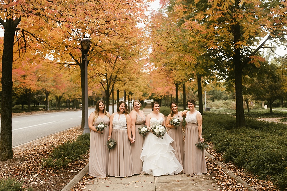 bride smiling with bridesmaids at headwaters park fall wedding