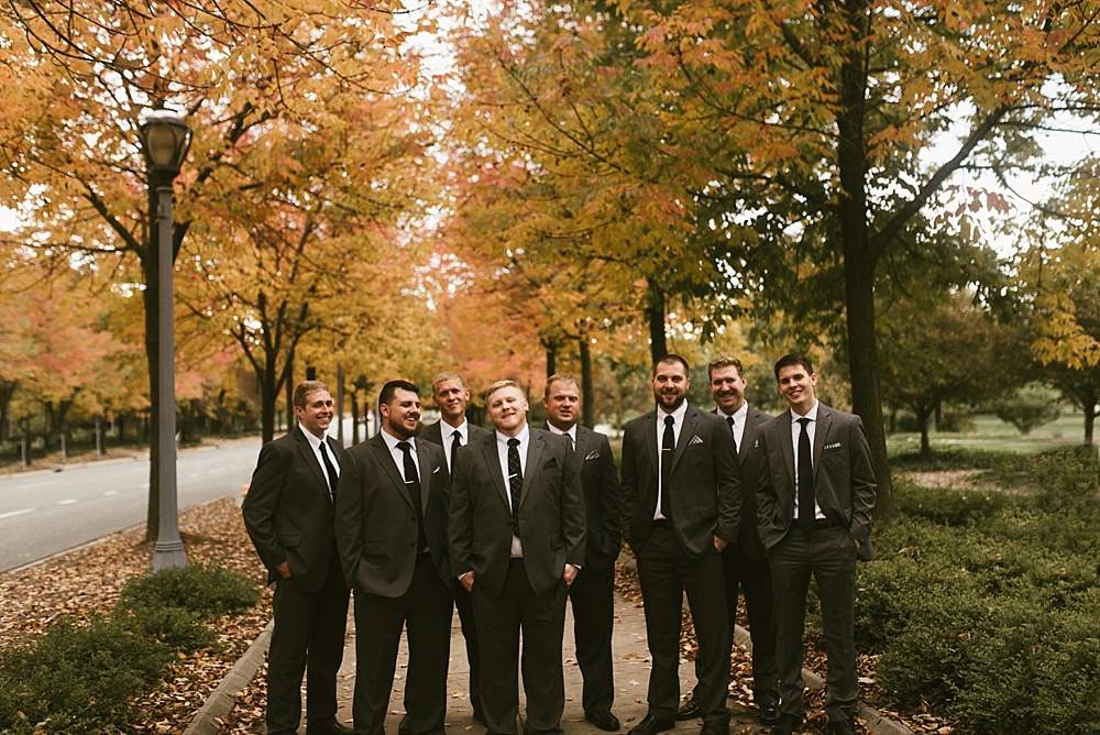 groom and groomsmen laughing at headwaters park fall wedding