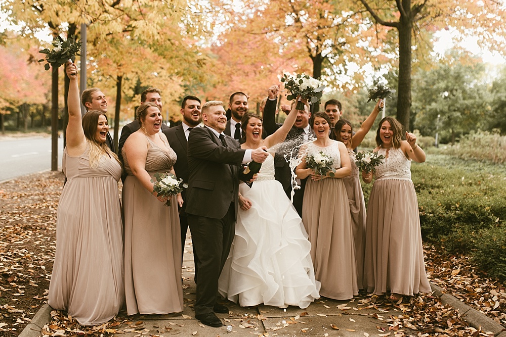 wedding party and bride and groom cheering at headwaters park fall wedding