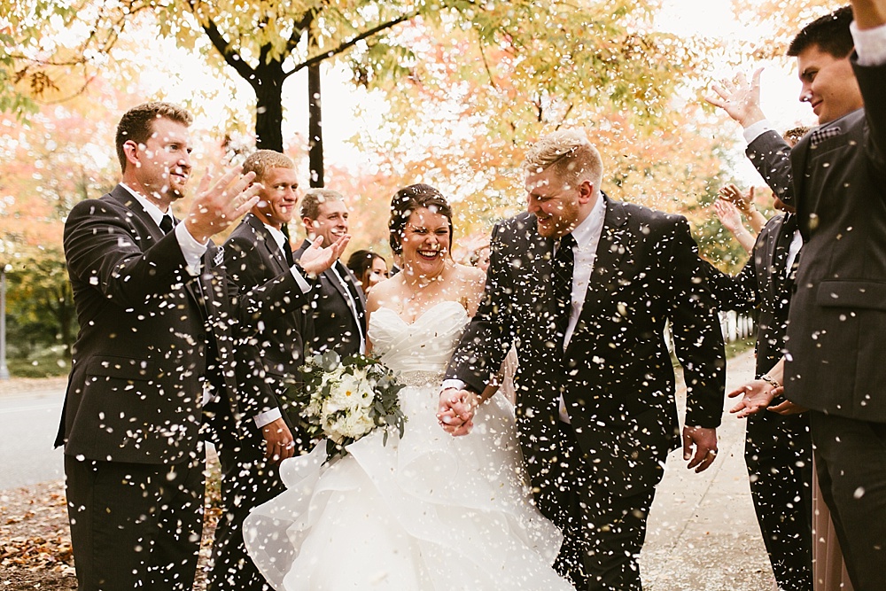 wedding party throwing confetti for bride and groom at headwaters park fall wedding
