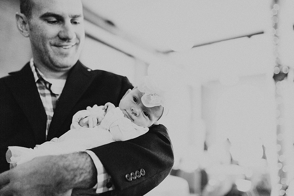 groom holding baby at bergstaff place fall wedding