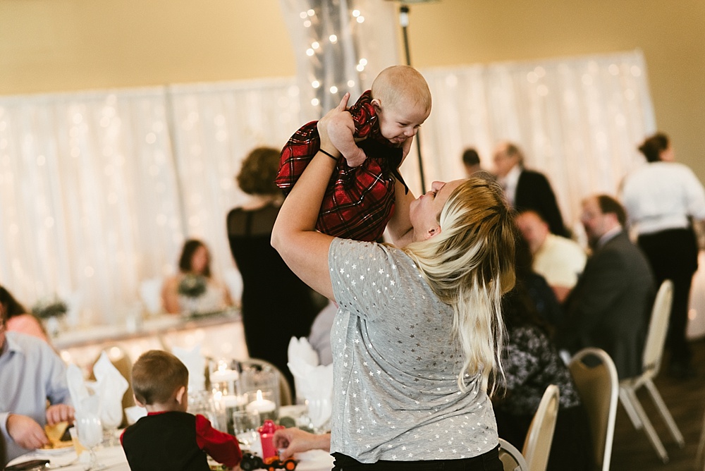 reception guest playing with baby at bergstaff place fall wedding