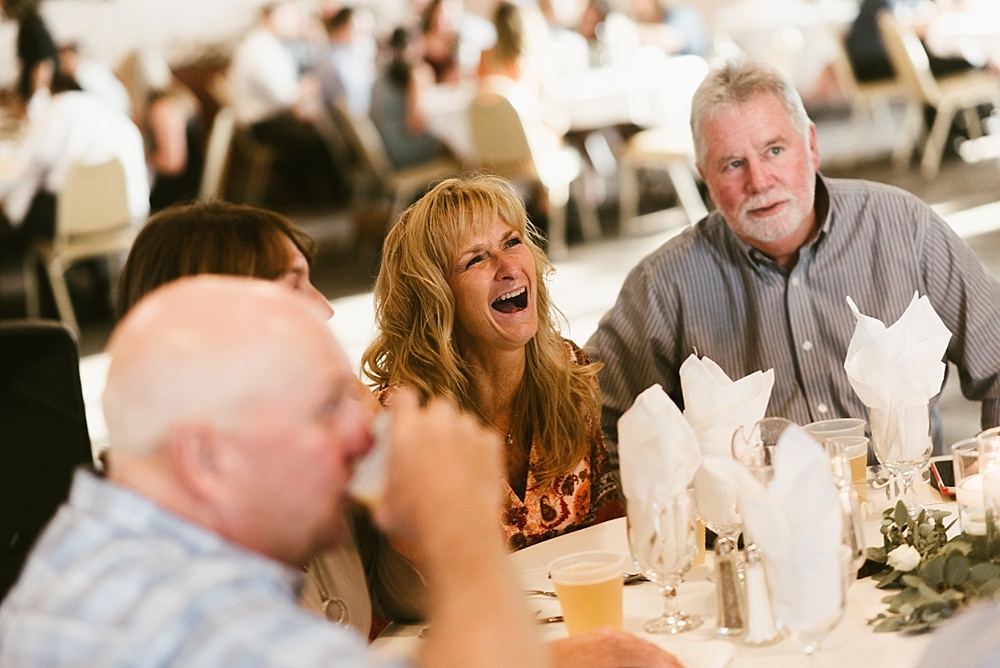 wedding guests laughing at bergstaff place fall wedding