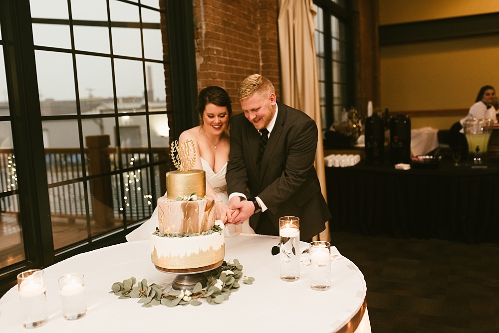 couple cutting cake at bergstaff place fall wedding